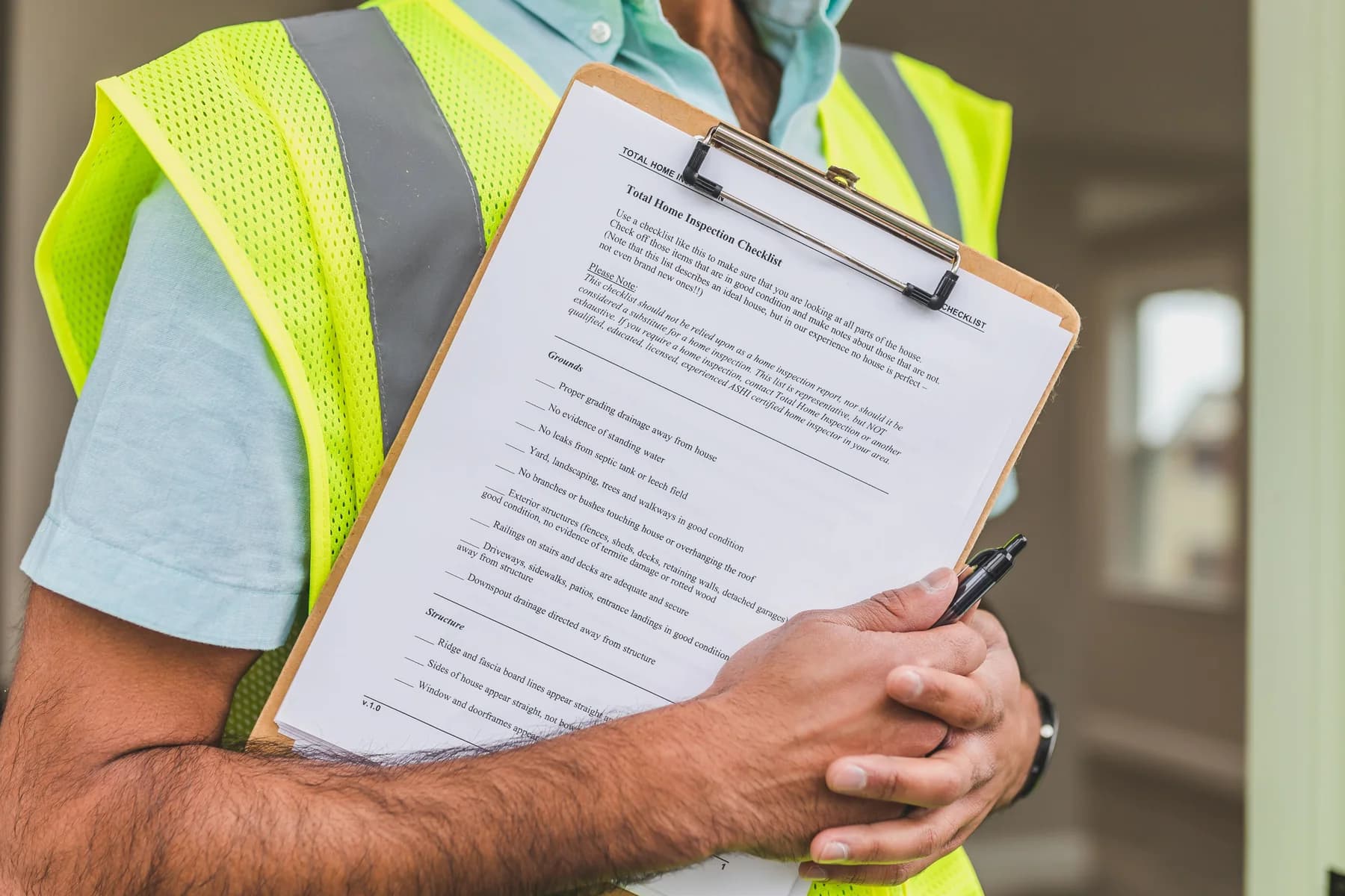 Property professional holding a home-inspection checklist.